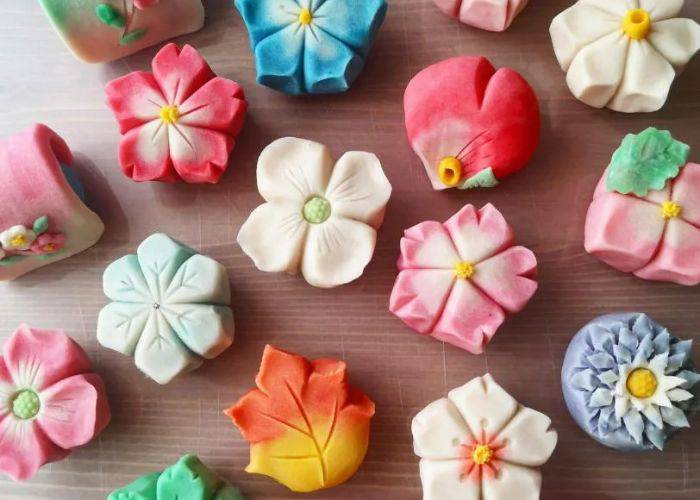 A selection of colorful wagashi sweets in different seasonal designs.